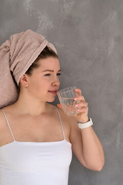 Woman drinking water after skincare.