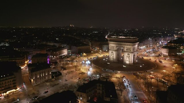 Triumphal Arch at night, Paris. Aerial drone sideways and panoramic view