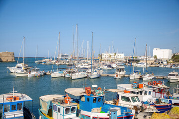 Crete island, destination Greece. Moored vessel with mast and fishing boat at Heraklion old harbor.
