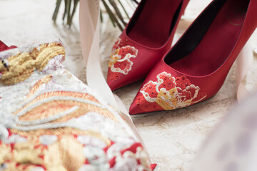 Traditional Chinese wedding attire and embroidered shoes displayed