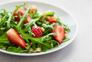 Fresh Strawberry Arugula Salad With Pine Nuts Served on a Bright Day