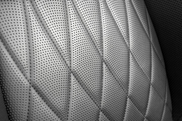 Part of leather car headrest seat details. Сlose-up black perforated leather car seat. Skin texture