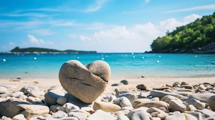 Rolgordijnen Vacation summer holiday travel tropical ocean sea panorama - Close up of stone heart on stone beach, with ocean or lake landscape in the background. © May