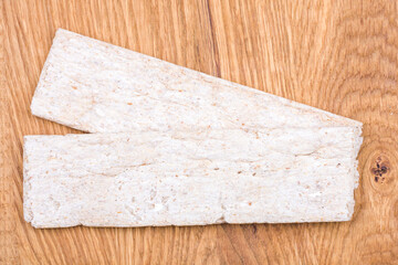 Crispbreads on a wooden background, top view