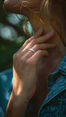 a woman hand wearing a silver plain ring 