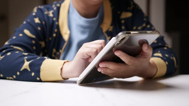 Holding a tablet with her left hand and using the other hand to browse the internet to look for some information and to check her social media status.