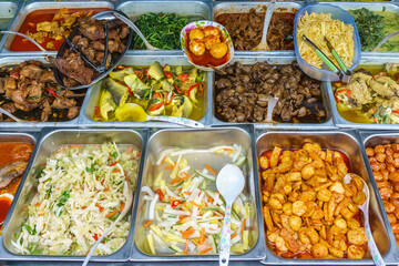 Variety of delicious Malaysian home cooked dishes sold at street market stall in Kota Kinabalu Sabah
