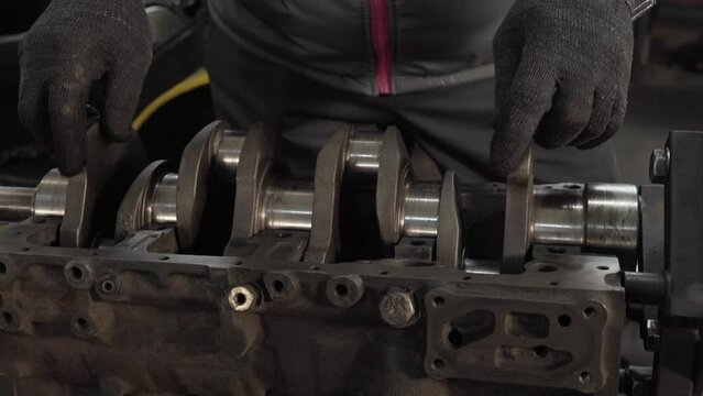 master inserts crankshaft into engine