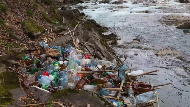 uncultured people throw garbage into the river, fast water carries polyethylene and other non-degradable waste of civilization into large rivers, littering their banks with plastic.