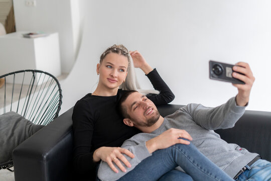 Smiling Couple Taking a Cozy Selfie Together on a Relaxed Afternoon Indoors