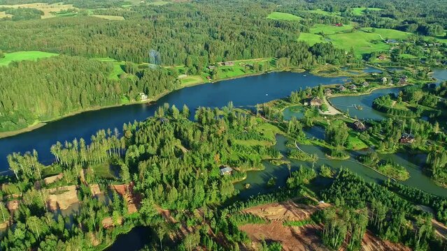 High angle drone panning view of the green nature of Amatciems in Latvia