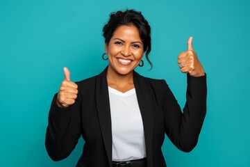 The successful Indigenous businesswoman in her mid-40s, against a light turquoise background