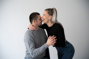 young man and woman whisper a secret in each other ear With Expressions of Surprise and Excitement