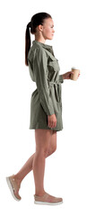 Side view of walking woman holding a coffee cup, wearing casual clothes, against a white...