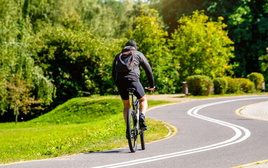 Cyclist ride on the bike path in the city Park
