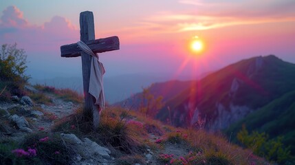   A cross atop a hill as the sun sets, distantly behind it, with pink flowers in the foreground - obrazy, fototapety, plakaty