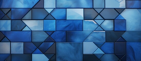 Blue glass wall displaying a striking pattern made of segmented triangles in a close-up view