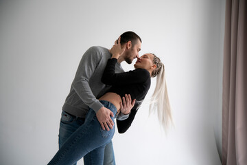 Portrait of a White Serene Couple Embracing in a Tender Moment Against a Neutral Background