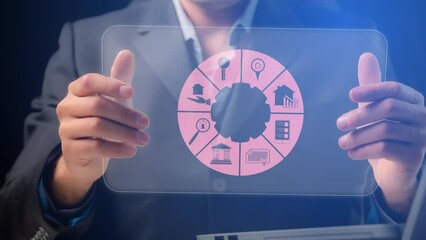 A pie chart with symbols for supporting real estate transactions on the transparent screen of a demonstration tablet in the hands of a business trainer. Cg