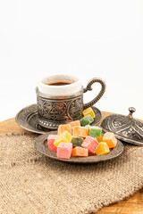 Turkish Coffee with Turkish Delight on authentic metal plate, isolated on white background