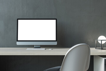 Close up of contemporary white mock up computer screen at modern designer office workplace in interior. Concrete wall background. 3D Rendering.