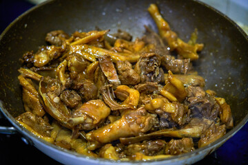 A Chinese chef is cooking braised duck