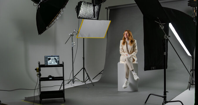 Young blonde woman model at photo studio with professional equipment