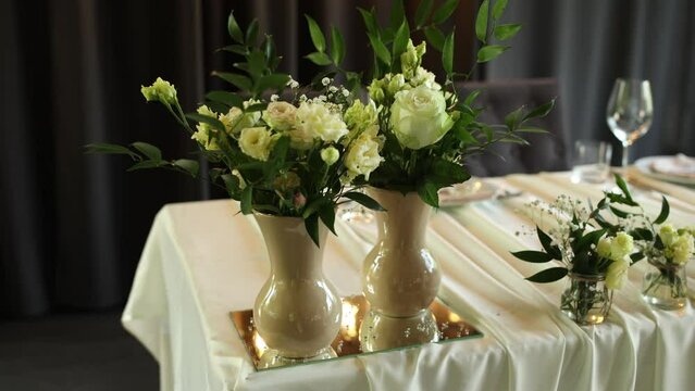 a beautiful wedding table with decor of flowers food and drinks for an banquet in the restaurant