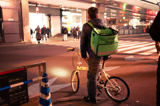 Tokyo, Japan - March 2, 2024 : Uber Eats rider delivering food at Akihabara.