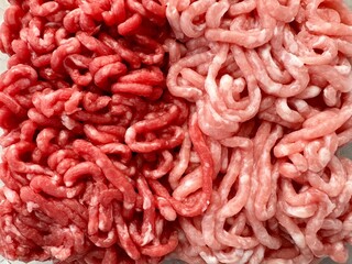 Minced meat, half pork half beef different meat mixture close up top view