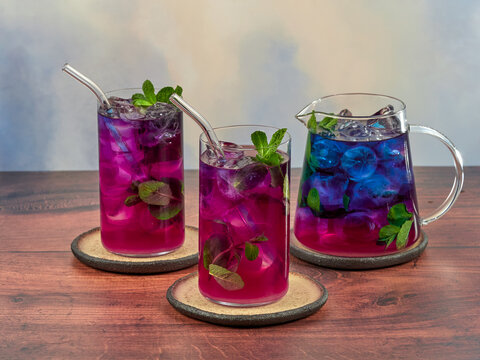 Iced blue tea is made from Anchan flowers, also known as butterfly peas (Clitoria ternatea). It turns purple when lemon is added.