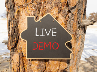 Live demo symbol. Concept words Live demo on beautiful black house blackboard. Beautiful tree...