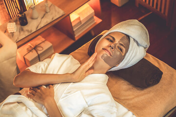 Serene ambiance of spa salon, top view woman customer indulges in rejuvenating with charcoal face...