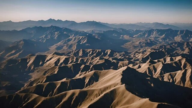 Aerial drone shot of a mountain range in the style of cinematic video, shallow depth of field, subject in focus, dynamic movement