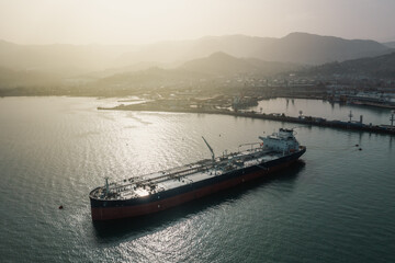 Tanker moored at oil terminal, intricate part of global petro resource trade, aerial view from...