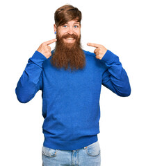 Young irish redhead man wearing casual clothes smiling cheerful showing and pointing with fingers teeth and mouth. dental health concept.