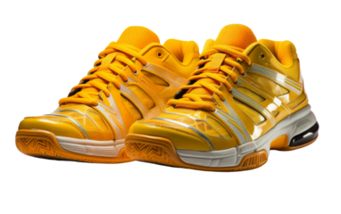 A pair of bright yellow tennis shoes stands out against a clean white background