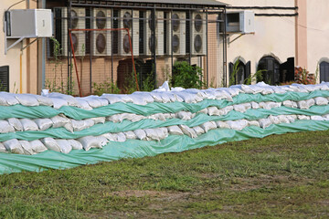 Wall of Sandbags and Tarp for Industrial Building Flood Protection Prevention