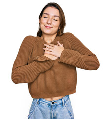 Young caucasian girl wearing casual clothes smiling with hands on chest with closed eyes and grateful gesture on face. health concept.