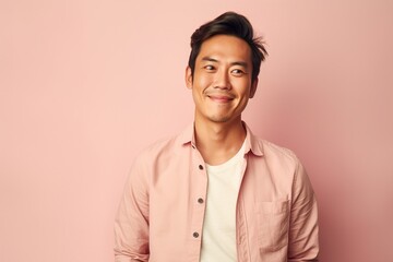 Fototapeta premium A man with a mustache and a pink shirt is smiling