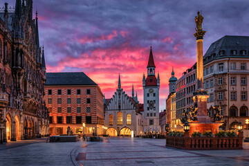 The beautiful old town of Munich, Germany, with Town Hall at the Marienplatz Square during a fiery sunrise - 774749104