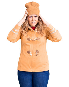 Young caucasian woman wearing casual clothes suffering from headache desperate and stressed because pain and migraine. hands on head.