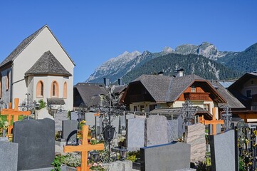View of the cemetery and mountains in the background. Haus im Ennstal, Austria, Europe.