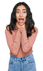 Obraz premium Hispanic teenager girl with dental braces wearing casual clothes shouting and suffocate because painful strangle. health problem. asphyxiate and suicide concept.