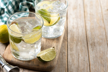 Glass of vodka tonic cocktail on wooden table