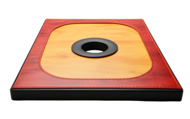A red and black square object with a central hole, standing out against a plain background