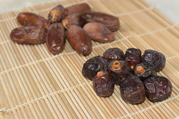 Two type of date fruit, Lulu and Tunisian dates. Lulu type is much smaller and dark compared to the...