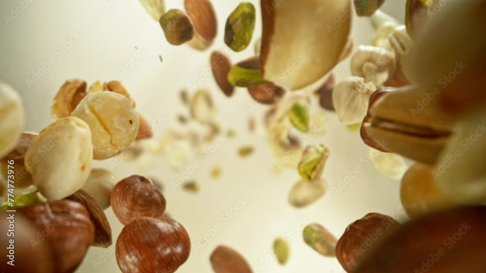Poster super slow motion of flying nuts mix in rotating movement. filmed on high speed cinema camera , 1000