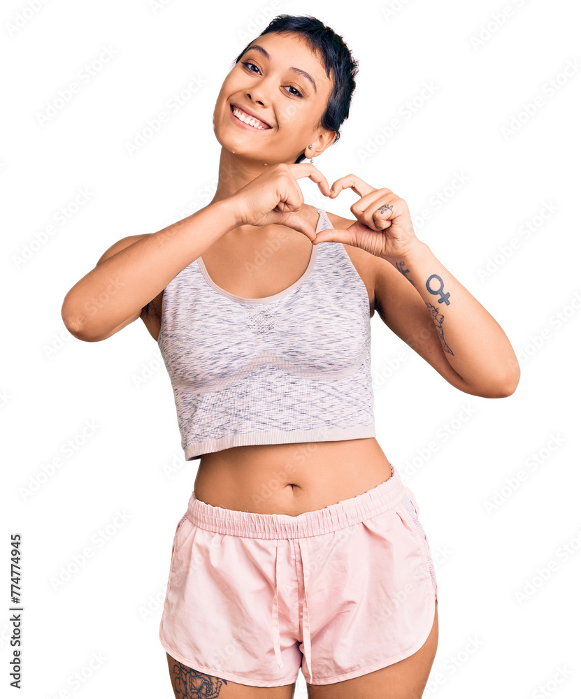 Poster Young woman wearing sportswear smiling in love showing heart symbol and shape with hands. romantic concept.