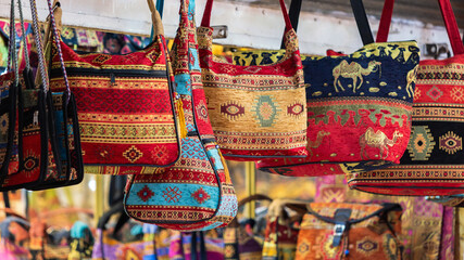 Colorful Turkish souvenir bags on display, rich in cultural patterns
